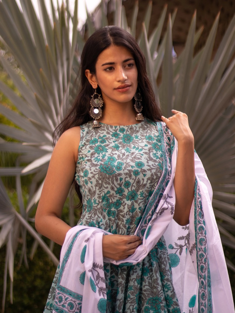 Teal floral kurta and white dupatta among fan palms, silver jhumkas, portrait by Curtain Drop Media